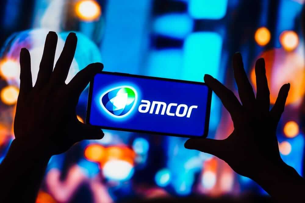 Amcor Plc phone in hands by- rafapress via Shutterstock